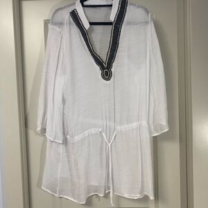 White bathsuit cover up with beading along neckline